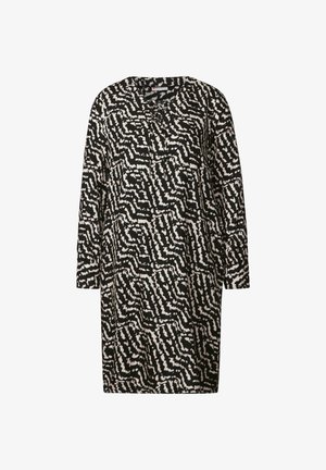 Czarna i kremowa sukienka w geometryczny wzór, z okrągłym dekoltem, długimi rękawami i luźnym krojem. Tkanina wydaje się gładka i lekka.