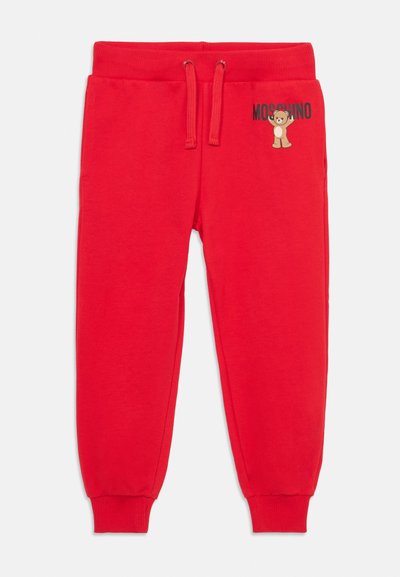 Röda sweatpants i mjukt tyg med elastisk midja, justerbar dragsko och tryckt teddy-björn-logotyp med "MOSCHINO"-text.