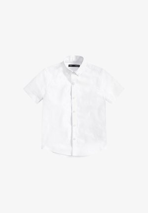 Chemise blanche à manches courtes avec boutons, dotée d’un col classique et d’un ourlet droit. Confectionnée dans un tissu lisse et léger.