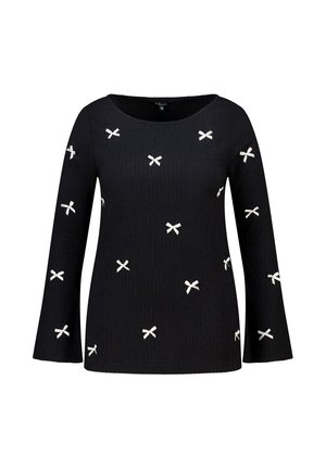 Haut noir à manches longues en tissu texturé avec de petits motifs de nœuds blancs dispersés, doté d'un col rond et de manches légèrement évasées.