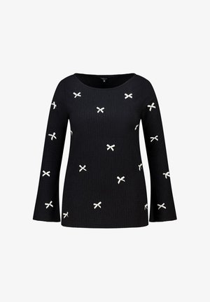 Zwart langermig topje met gestructureerde stof en verspreide kleine witte strikjes, voorzien van een ronde halslijn en licht uitlopende mouwen.