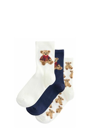 Three pairs of ankle socks: one white with a teddy bear, one navy blue, and another white featuring repeating teddy bear patterns. Cotton blend.