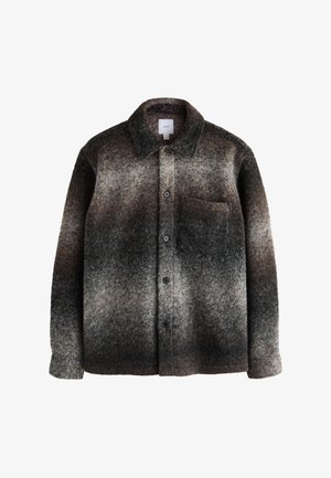 Chemise-veste en laine à manches longues avec boutons, col et poche poitrine, présentant un dégradé de couleur du gris foncé au gris clair.