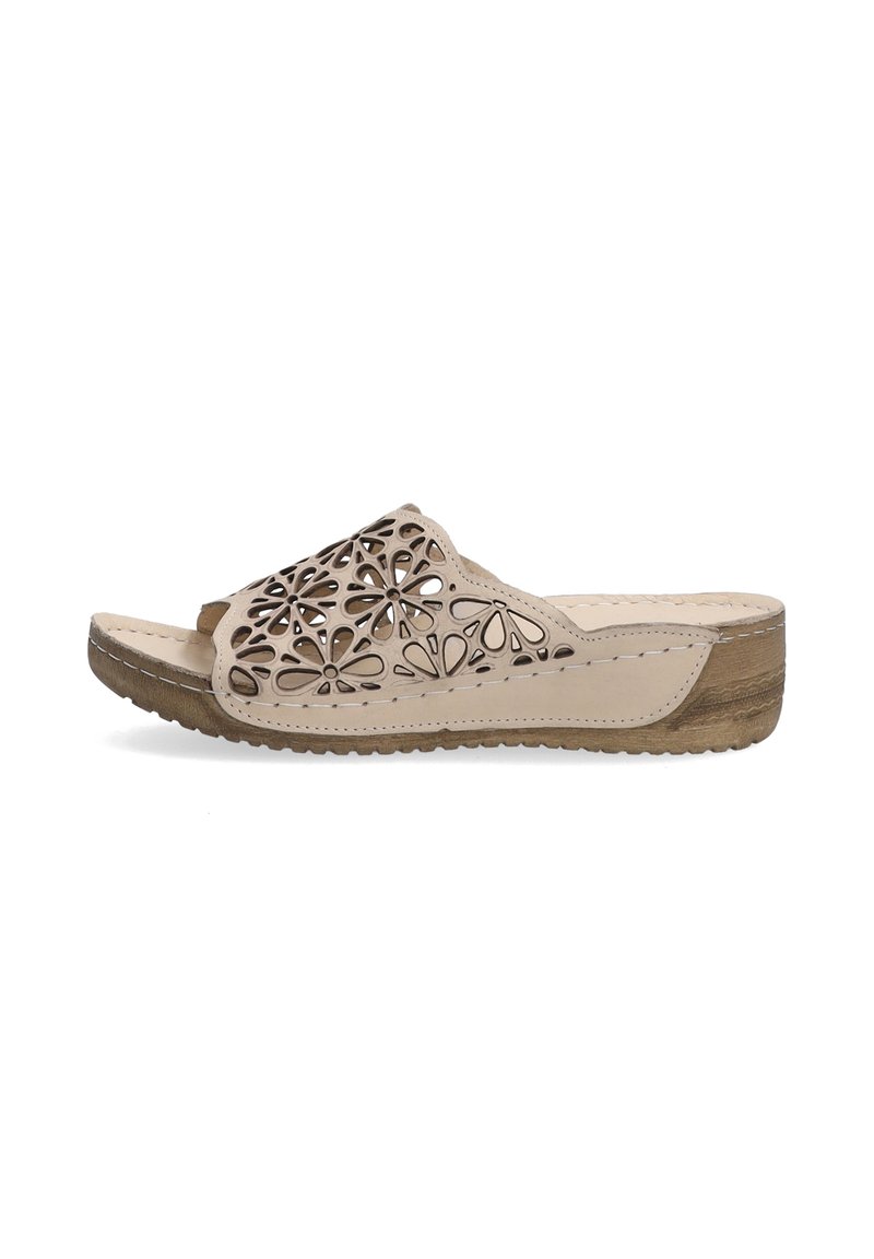 Beige slide sandal with cutout floral design, tan sole, and textured accents. Features an open toe and contoured footbed for comfort.