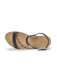 Black leather sandal with braided straps and a smooth tan insole. Features a gold hardware accent and detailed stitching along the edges.