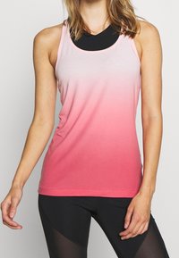 Pink ombre tank top with a fitted design, featuring a rounded neckline and thin straps. Soft fabric texture. Layered over a black base layer.