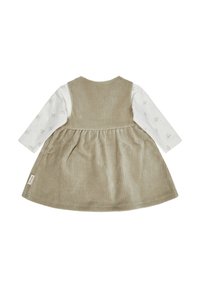 Hellbeige Cordkleid mit schwingendem Rock, langen weißen Ärmeln mit Blumenmustern und einem Etikett am Saum. Rückansicht.