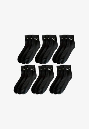Schwarze Socken, Baumwollmischung, mit gerippten Bündchen, mit einem weißen Logo auf der Oberseite. Set aus zwölf Paaren, mittlere Höhe, glatte Textur.