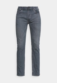 Mörkblå denimjeans med rak passform. Har bältesöljer, framfickor och dragkedja. Sömmen är kontrasterande i färg.