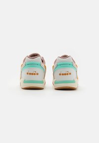Sneakers featuring a white, mint green, and orange color scheme, with a suede and mesh upper, padded collar, and rubber sole. Logo on heel.