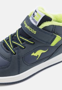 KangaROOS-sneakers in marineblauw en limoengroen, met een gestructureerde synthetische bovenkant, klittenbandsluiting en een fluffy voering voor extra comfort.
