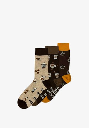 Three pairs of coffee-themed crew socks in beige, brown, and dark brown with coffee cups, beans, and pots designs, each with contrasting toes and cuffs.