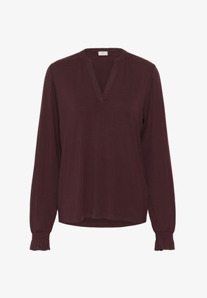 Haut bordeaux à manches longues avec un col en V, des poignets froncés et une coupe décontractée. Tissu doux avec une texture lisse, idéal pour superposer.