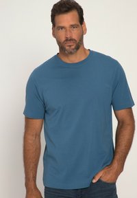 Modrá bavlněná tričko s klasick�ým kulatým výstřihem, krátkými rukávy a volným střihem, s jednoduchým šitím a minimálními ozdobami.