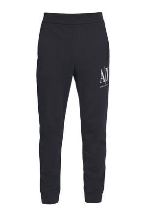 Schwarze, schlanke Jogginghosen mit elastischem Bund und Bündchen, mit weißem AX Armani Exchange-Logo am oberen linken Oberschenkel.