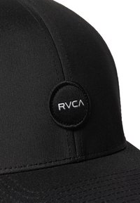 Black cap featuring a smooth texture, structured shape, and a round RVCA logo in white on the front. Detailed stitching visible along seams.