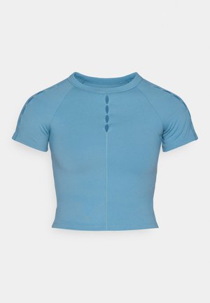Light blue, short-sleeve top made of stretchy fabric. Features a round neckline and decorative button-like cutouts centered down the front.