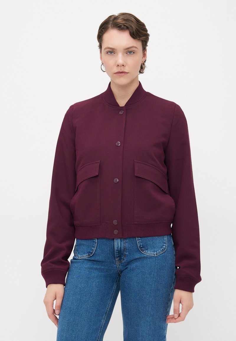Burgundy bomber jacket with ribbed cuffs and collar, front button closure, and two large front pockets. Smooth fabric texture.