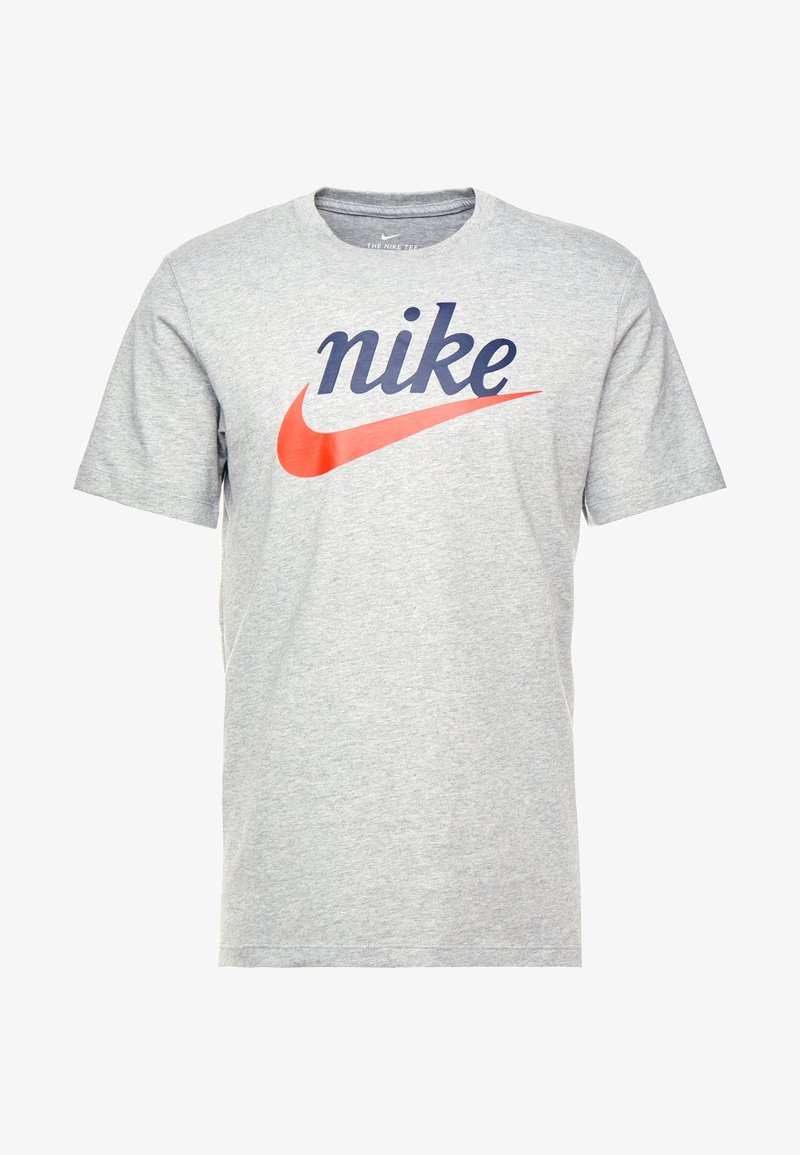 Gray cotton t-shirt featuring a large navy blue "nike" logo and a red Nike swoosh on the front. Short sleeves, round neckline.