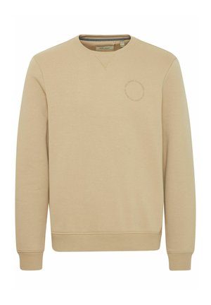 Sudadera de cuello redondo en color beige con puños y dobladillo acanalados. Presenta un logo sutil impreso en el centro. Textura suave y ajuste relajado.