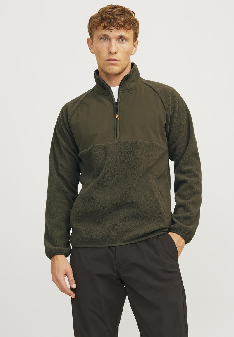 Olive green fleece pullover with a half zip, featuring a textured lower panel and smooth upper section, relaxed fit, and long sleeves.