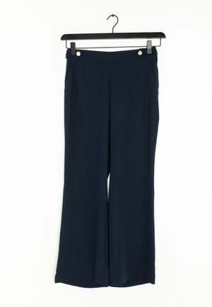 Navy wide-leg trousers made from a smooth fabric, featuring a high waistband and two side pockets with button accents.