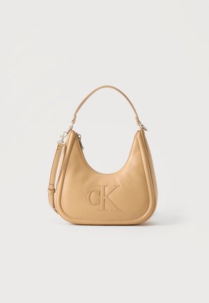 Tan leather shoulder bag with embossed "cK" logo, top handle, and detachable strap on plain white background.