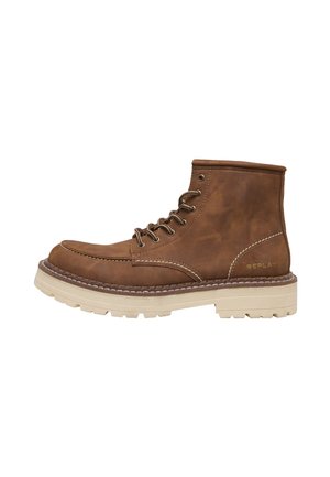 Brown leather ankle boot with beige thick rubber sole, lace-up front, and visible stitching on white background.