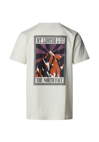 Krátký rukáv, krémové bavlněné tričko s barevným grafickým motivem hor na zádech, s nápisem "MT. LHOTSE" a "THE NORTH FACE."