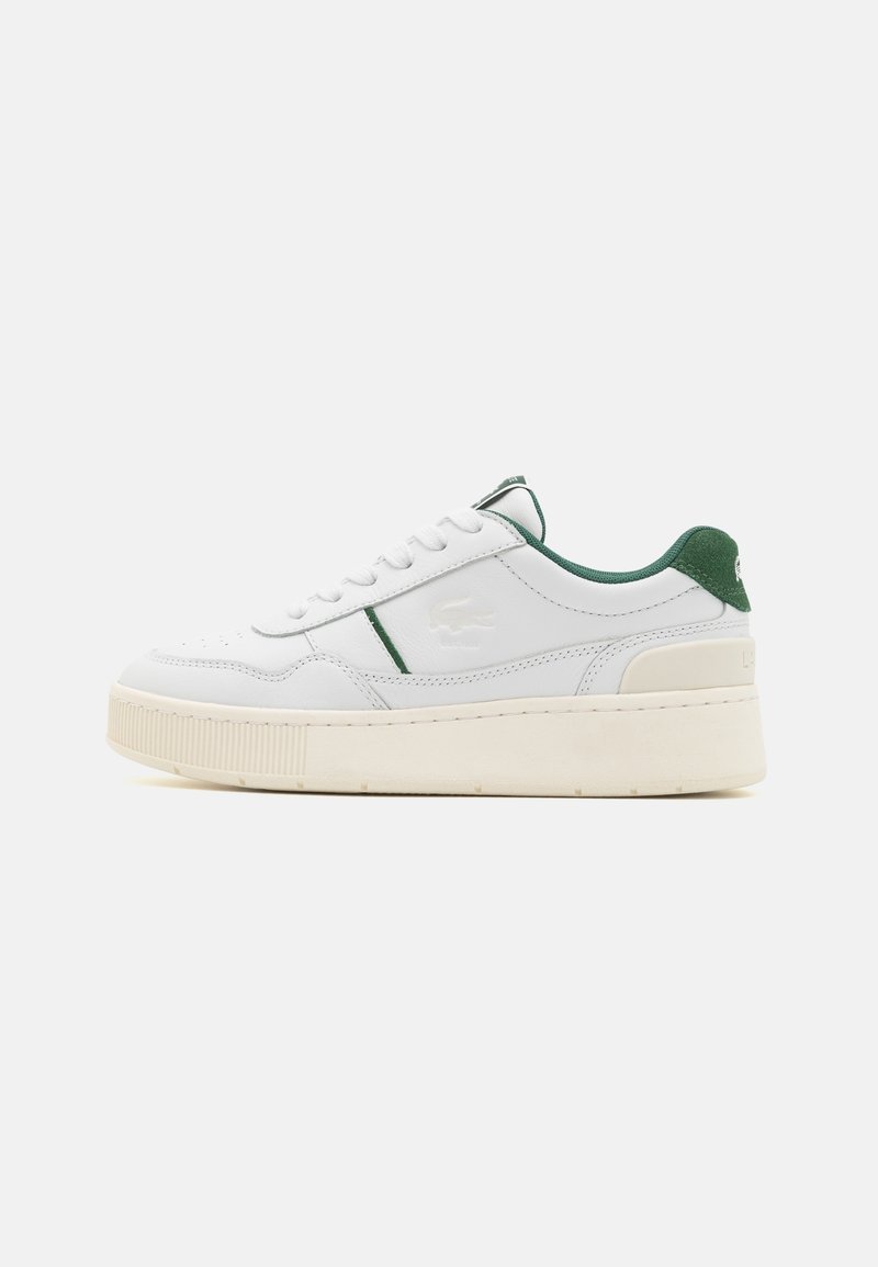 White leather sneaker with green accents. Features a textured sole, round toe, lace-up design, and embossed logo on the side.