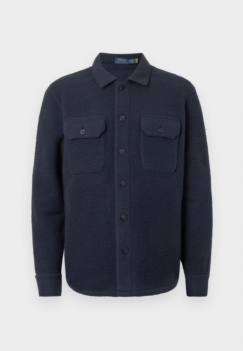 Navy blue fleece shirt jacket with a textured surface, two chest pockets with button closures, and a pointed collar.