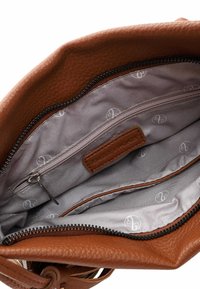 Brown leather handbag interior with a texture pattern, featuring a gray lining with a subtle logo print, zippered pocket, and additional compartment.