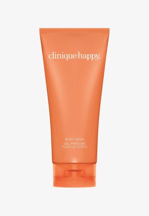 Tubetto arancione e spremibile di gel doccia Clinique Happy con testo bianco, caratterizzato da un fondo arrotondato e un tappo a scatto.
