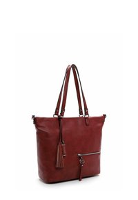 Borsa tote in pelle rossa con due manici, una tasca frontale con zip e dettaglio a frange. Texture liscia e forma rettangolare.