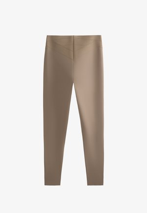 Brown leggings with a smooth texture, featuring a high waistband and angled seam details, designed for a fitted appearance.