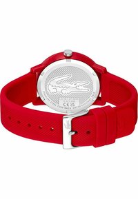 Cinturino in silicone rosso con retro in acciaio inossidabile, caratterizzato da una superficie testurizzata e un logo. Chiusura con fibbia regolabile. Impermeabile fino a 5 bar.