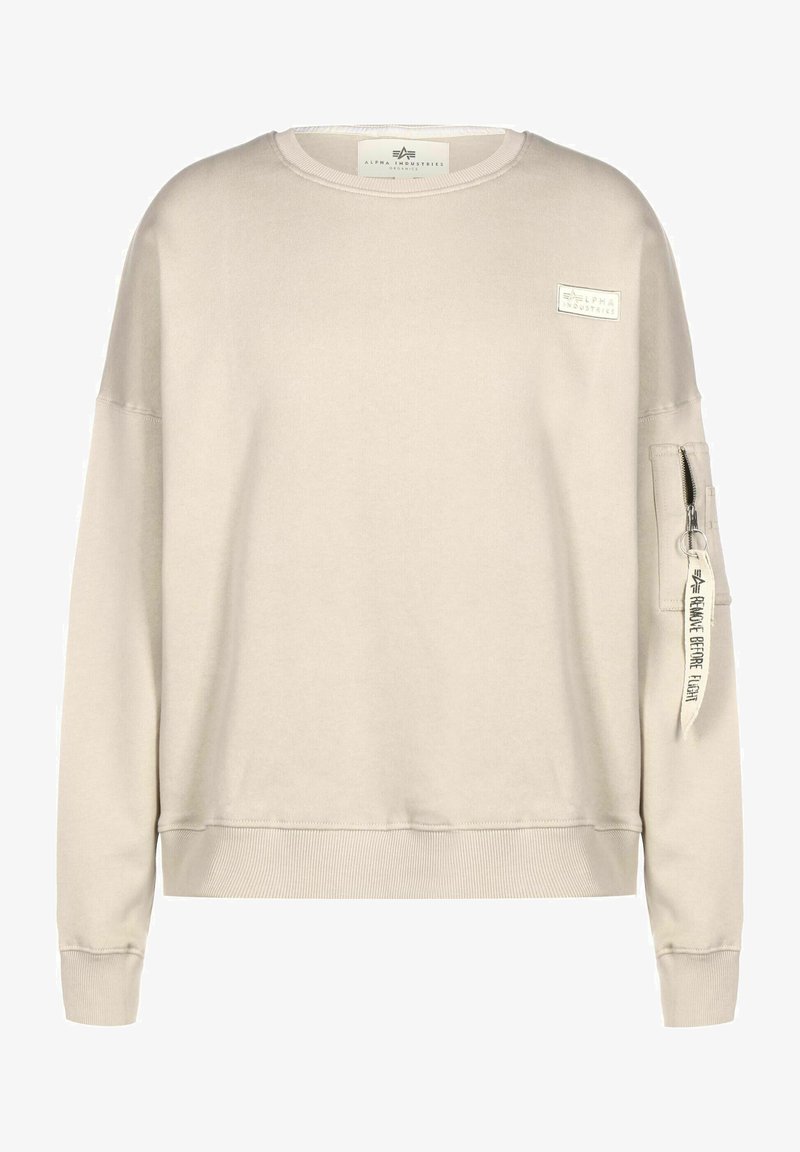 Beżowy sweter z okrągłym dekoltem, żebrowanymi mankietami i dołem. Posiada naszywkę na klatce piersiowej oraz kieszeń na suwak na rękawie z metką.