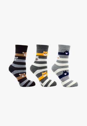 Gestreifte Socken in Schwarz, Grau und Weiß mit Tiermustern; Merkmale sind kontrastreiche Farben, cartoonartige Tiergesichter und weiches Material.