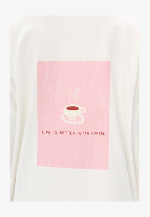 Sweat-shirt blanc avec un graphisme rectangulaire rose. Il représente une tasse de café fumante sur une soucoupe blanche avec le texte "La vie est meilleure avec du café."