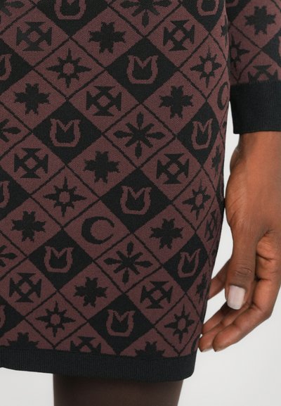 Knitted dress featuring a geometric pattern in black and burgundy, with various symbols. Long sleeves and a ribbed hem detail.