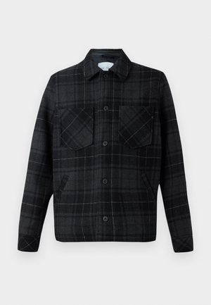 Plaid shirt jacket in black and gray wool blend, with two chest pockets, button closure, and contrasting white stitching.