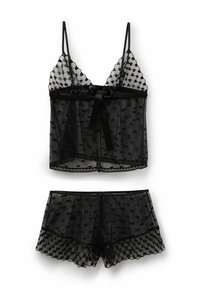 Schwarzes durchsichtiges Dessous-Set mit Herzmustern, bestehend aus einem Camisole mit dünnen Trägern und passenden Shorts mit gewellten Kanten.