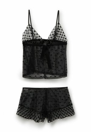 Schwarzes durchsichtiges Dessous-Set mit Herzmustern, bestehend aus einem Camisole mit dünnen Trägern und passenden Shorts mit gewellten Kanten.