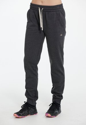 Pantalons de jogging gris en tissu doux, avec une taille élastique, un cordon de serrage, des poches latérales et un petit logo sur la cuisse.