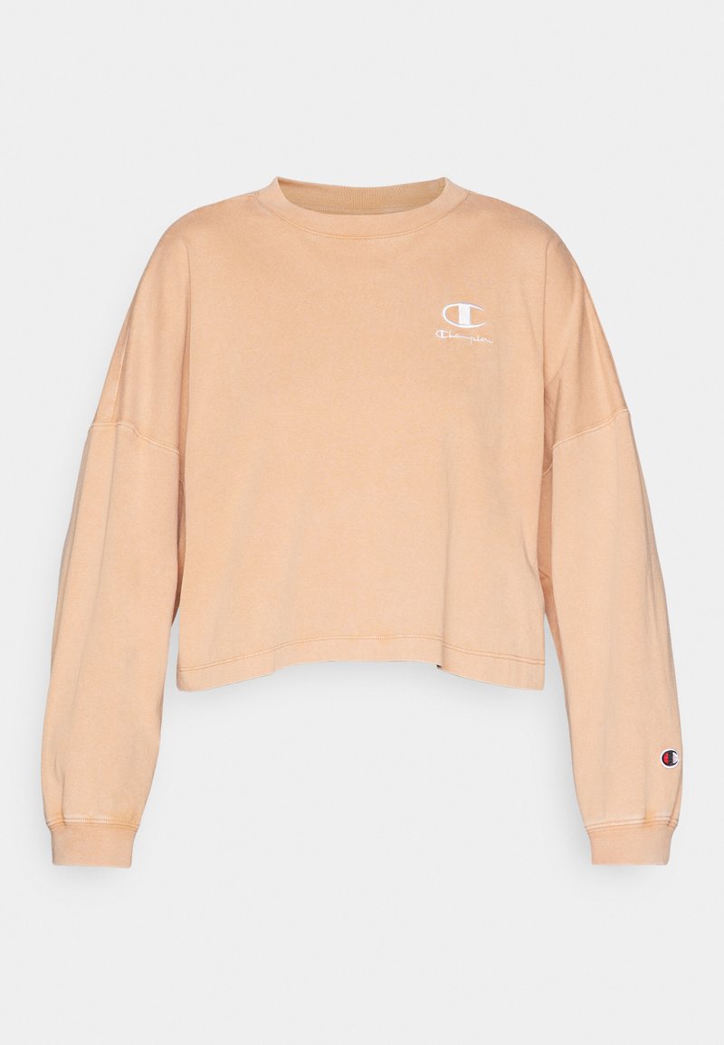 Skórzany, długi rękaw, wycięty sweatshirt w jasnopomarańczowym kolorze. Posiada małe białe logo na piersi oraz naszywkę z logo na rękawie.
