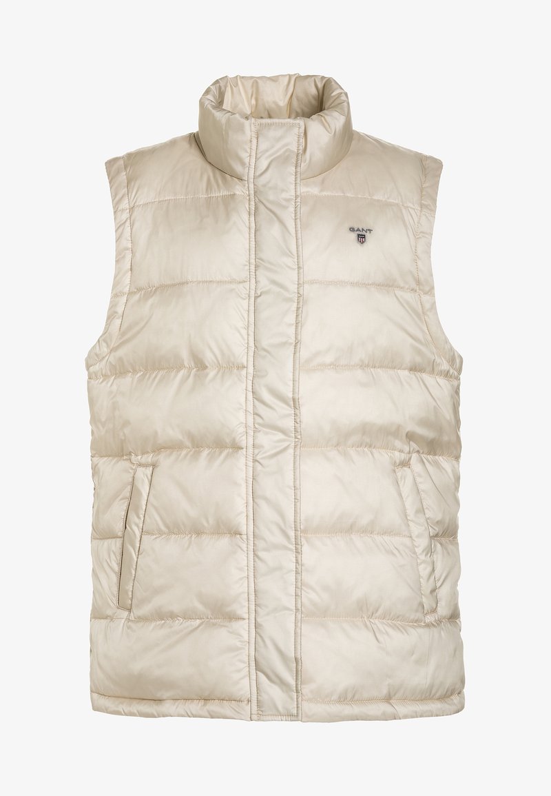 Veste sans manches matelassée beige avec col montant, poches latérales et petit logo Gant sur la poitrine gauche.