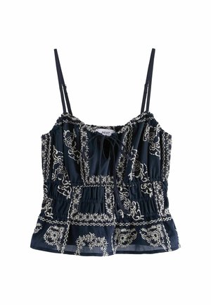 Navy blue camisole top with white floral embroidery, adjustable thin straps, cinched waist, and front tie detail.