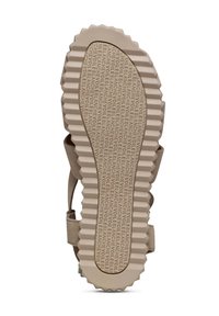 Suela de sandalia beige con estrías texturizadas, que presenta el nombre de la marca en relieve de manera repetida. Sujeción de la correa visible para ajuste. Material de goma.