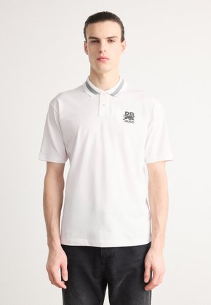 White polo shirt with a gray-striped collar, featuring a logo on the left chest. Short sleeves and a soft cotton texture.