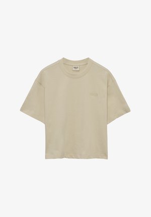 Beżowa krótka koszulka wykonana z miękkiego materiału, z okrągłym dekoltem i krótkim rękawem. Subtelny haft z logo z przodu.